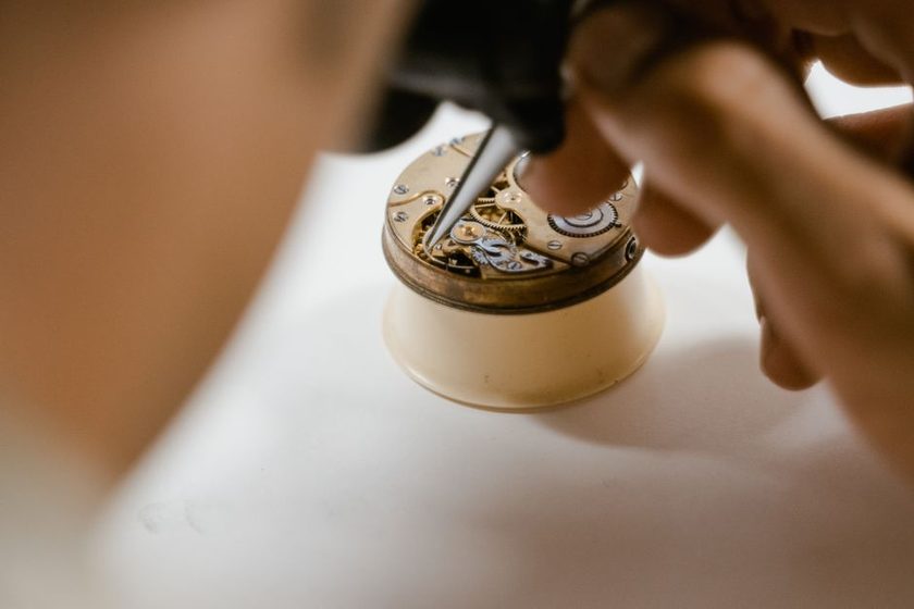 A vintage watch movement from the 1960s on a repair mat