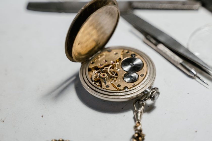 Small bottles of watch oil arranged next to an oiler